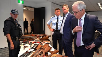 Australian prime minister Malcolm Turnbull looks at firearms handed in during a gun Amnesty in Australia. AAP/Joel Carrett / AAP via Reuters