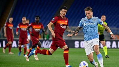 Lazio's Ciro Immobile, right, in action against Roma's Roger Ibanez. EPA