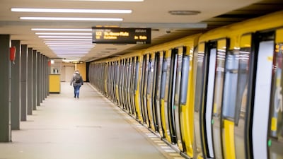 A woman walks on a deserted platform of the underground station Zoologischer Garten in Berlin Friday morning. AP