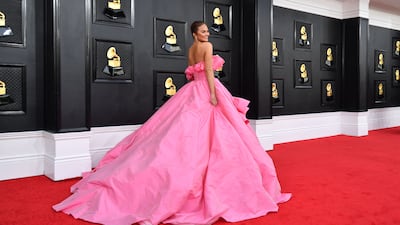 Chrissy Teigen made her red-carpet comeback in a pink Nicole + Felicia gown. AFP