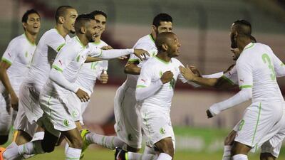 Yacine Brahimi, centre, celebrates with Riyad Mahrez, to his left, and other Algeria teammates after a goal in their Africa Cup of Nations qualifying win over Malawi on Wednesday to officially enter them into the 2015 tournament. Louafi Larbi / Reuters / October 15, 2014