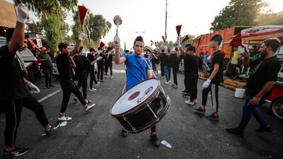 Iraqis whip themselves with chains during the Ashura commemoration period outside the Iraqi parliament, as Mr Al Sadr's supporters occupy the building for a fifth consecutive day. AFP