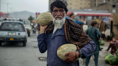 A fruit vendor at a market in Kabul, which is facing weak domestic demand for Afghan melons and watermelons, as export volumes to Pakistan, India and other Central Asian countries have reduced. EPA
