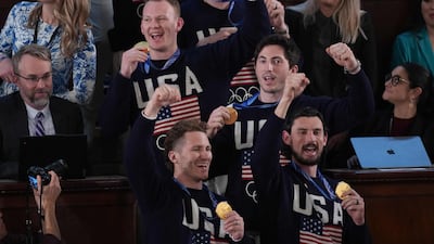 Members of Team USA Men's hockey team wave to the audience with their gold medals from the Winter Olympics. AFP