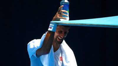 Novak Djokovic reaches for a water bottle. David Gray / Reuters