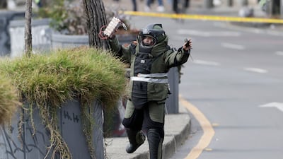 A police explosives officer inspects a suspicious package in Bogota, Colombia. EPA
