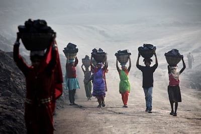 Villagers carry coal from a mine in Dhanbad, Jharkhand, India. Getty Images
