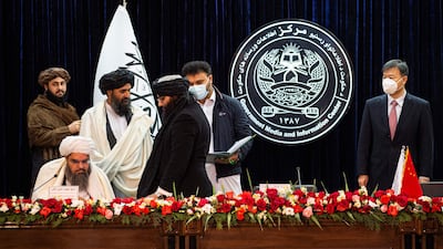Afghanistan's acting minister of mines and petroleum Shahabuddin Dilawar, sitting left, its acting first deputy prime minister Abdul Ghani Baradar, second left, and China's ambassador to Afghanistan Wang Yu at the signing in Kabul. AFP