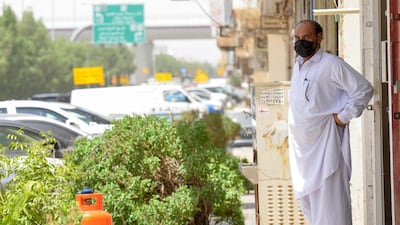 A mask-clad labourer stands outside his workplace in the Saudi capital Riyadh, as restrictions are eased amid the Covid-19 pandemic. AFP