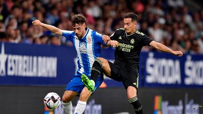 Real Madrid midfielder Lucas Vazquez challenges for the ball against Espanyol's Javi Puado. Reuters