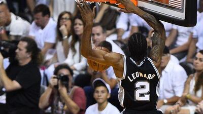 San Antonio Spurs forward Kawhi Leonard slam dunks the ball against the Miami Heat in Game 3 of the NBA Finals on Tuesday night. Larry W Smith / EPA / June 10, 2014