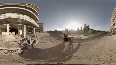 Syrians travel down a ruined street near the Aleppo Bridge to move away from snipers. Christian Stephen / Ryot via AP