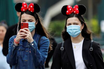 FILE PHOTO: Visitors wear protective face masks at Disneyland Paris, July 15, 2020. REUTERS/Charles Platiau/File Photo