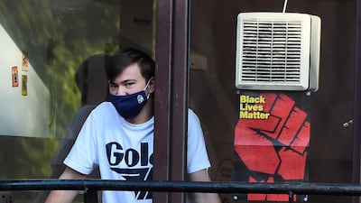 A first year student looks out of a window at Cairncross House student residence in the West End of Glasgow, Scotland. AFP