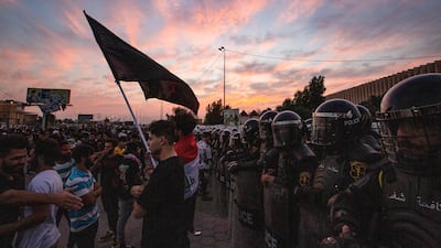 Iraqi riot police form a shield as demonstrators gather near the local administration building in the southern city of Basra on November 6, 2020, during an anti-government protest. AFP