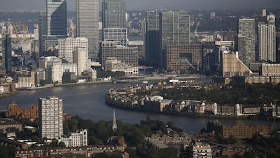 The 34 office buildings, 300 shops and restaurants that make up Canary Wharf, above, are a shiny steel and glass jewel in a once-grimy nook, where the River Thames meanders through an industrial landscape. Simon Dawson / Bloomberg News