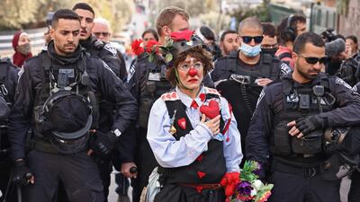 Az-Oolay the clown in front of Israeli police officers during a demonstration in the Sheikh Jarrah neighbourhood of occupied East Jerusalem, in February. AFP