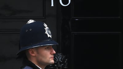 A police officer outside 10 Downing Street in London. The Metropolitan Police have issued 20 penalty notices so far over Covid rule-breaking parties in British PM's official residence. EPA
