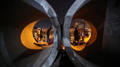 Street vendors work on a roadside in Mumbai. Divyakant Solanki / EPA