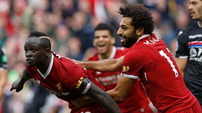 Liverpool's Sadio Mane, left, celebrates scoring his side's first winner against Crystal Palace at Anfield, Liverpool. Martin Rickett / PA
