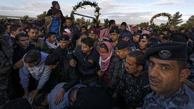 Members of the Jordanian gendarmerie, other police, and residents mourn the death of Lieutenant Colonel Saed Al Maaytah, who was killed in the Karak shootings a day before, at his funeral close to the city on December 19, 2016. Ben Curtis/AP Photo