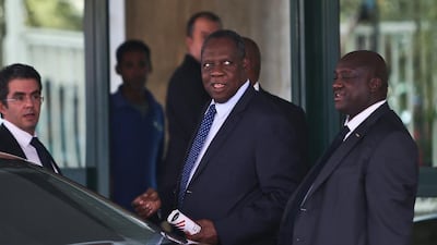 Confederation of African Football (CAF) president Issa Hayatou, centre, leaves after a meeting in Cairo on November 11, 2014, to decide on host Morocco's request to postpone the 2015 Africa Cup of Nations tournament because of the Ebola epidemic, possibly leading to its cancellation or relocation. Morocco has been stripped of hosting the Africa Cup of Nations and the national side flung out of the competition after the country said it wanted to postpone the tournament due to fears over the Ebola epidemic, CAF announced. Mohamed El Shahed / AFP