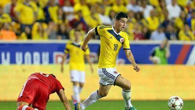 Colombia's James Rodriguez dribbles around a Canadian defender during a 1-0 friendly win outside New York City on Tuesday night. Adam Hunger / USA Today Sports / October 14, 2014
