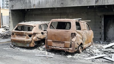 Falling debris set fire to several vehicles that remain on site today