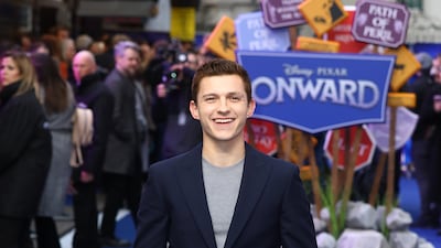 Tom Holland, in a grey T-shirt and navy Enzo suit, attends the 'Onward' UK premiere in London on February 23, 2020. Getty Images