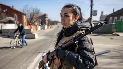 A volunteer takes position at a checkpoint in a district of Kyiv as Russian forces try to encircle the Ukrainian capital. AFP