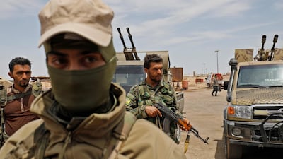 Members of the Syrian Democratic Forces gather at the al-Tanak oil field as they prepare to relaunch a military campaign against ISIS near Abu Kamal, in the province of Deir Ezzor in eastern Syria. AFP/Delil Souleiman