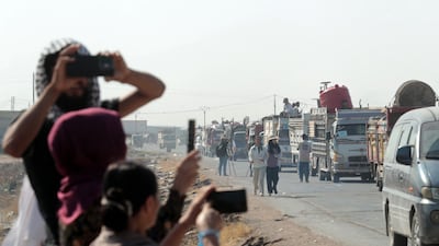 Onlookers take pictures. AFP