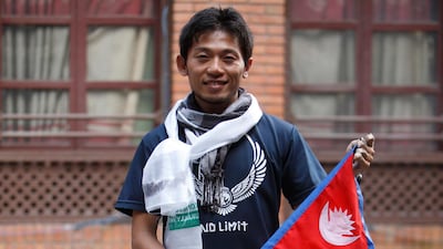 Nobukazu Kuriki holding a Nepalese flag in Kathamandu. Bikram Rai / AP