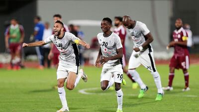 Al Sadd's Nadir Belhadj (39) and Musaab Khidir Mohamed (70) celebrate defeating Al Wahda during their AFC Champions League play-off match. Christopher Pike / The National