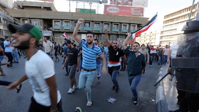 Iraqi protesters run as they try to reach to the gate of the the fortified green zone which is the headquarters of the Iraqi government during a demonstration at Tahrir square, central Baghdad. EPA