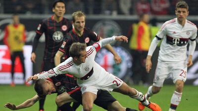 Bayern Munich defender Philipp Lahm, centre, and Frankfurt's Serbian defender Aleksandar Ignjovsk, left, vie for the ball. Daniel Roland / AFP