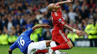 Jermaine Beckford, right, the Everton substitute, scythes down Martin Skrtel, the Liverpool defender.