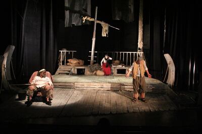 A shot of the actors on stage from the dark production 'Sea and Sand'. Al Shams Theatre