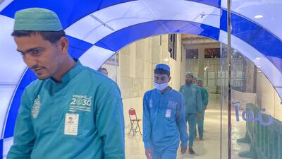 Workers pass through a self-sterilisation gate set up at an entrance of the Kaaba and the Grand Mosque, as a preventive measure in the Saudi holy city of Makkah. AFP