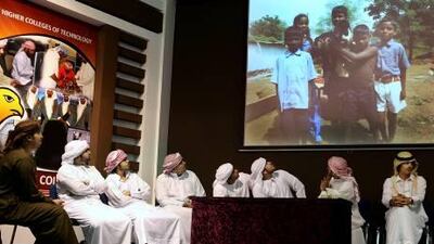 Some of the students from the Al Ain Men's College who went to India recently to volunteer to help build homes for the poor look at video footage from their trip during a recent program at their school. Delores Johnson / The National