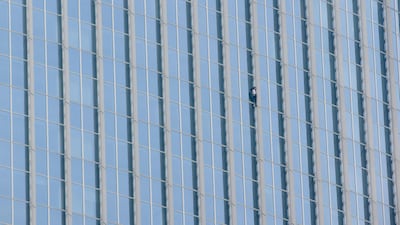 Alain Robert of France scales the exterior of the fifth tallest building in the world. Ed Jones / AFP