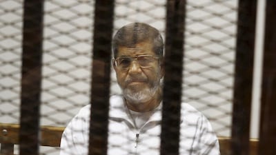 Egypt's ousted president Mohammed Morsi at an earlier hearing. He was sentenced to 20 years in prison over violence outside the presidential palace that killed protesters in December 2012. AP Photo