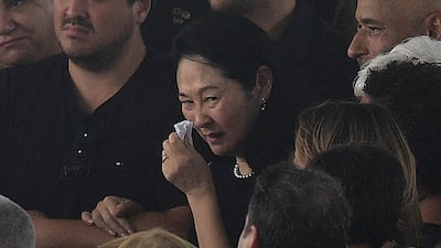 The wife of late Brazilian legend Pele, Marcia Aoki, during his wake at the Urbano Caldeira Stadium. AFP