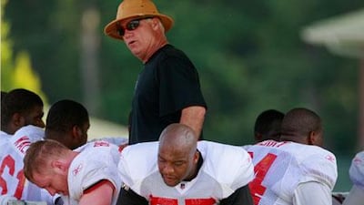 John Abraham, bottom centre, says Mike Smith, his head coach, standing, is a good listener.