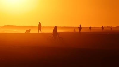 People walk at sunset along Roberta beach, Barcelona, on February 1. Reuters