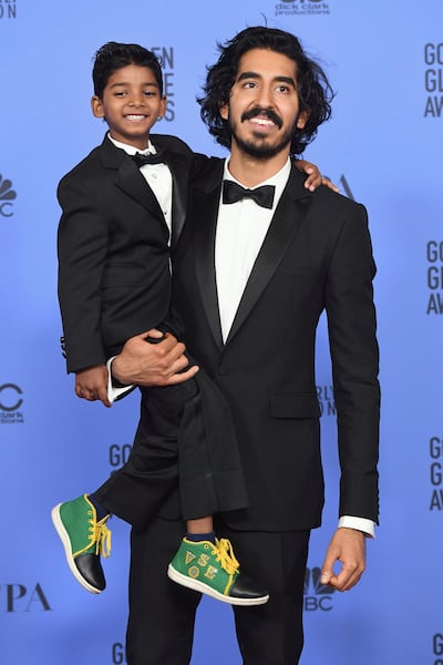 Actors Sunny Pawar and Dev Patel at the 74th Golden Globes. AFP