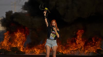 Activists use fire to blockade a motorway during a protest to demand the immediate release of hostages held by Hamas and call for the Israeli government to reverse its decision to take over Gaza city and other areas in the Gaza Strip, near the city of Lod, Israel. AP