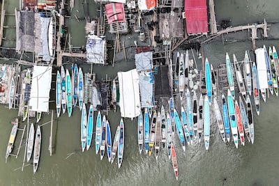 Wooden boats moored beside cramped houses on Pugad in Hagonoy town, Bulacan province. AFP