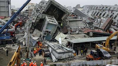 Rescuers search for survivors from a collapsed building following a 6.4 magnitude earthquake that struck the area in Tainan, Taiwan. More than 100 people remained missing in the building’s rubble. Ritchie B Tongo / EPA