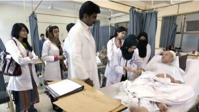A female Pakistani doctor examines a patient at the Dow Medical Institute for Health in Karachi.